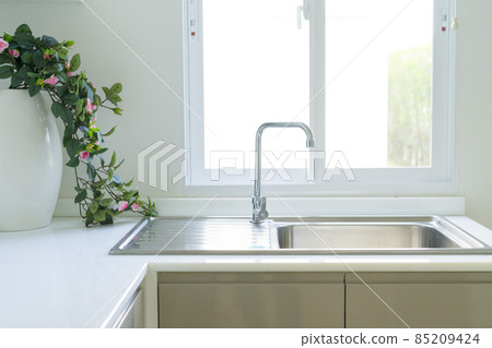 close up of a stainless steel kitchen sink close up of a stainless steel kitchen sink 85209424