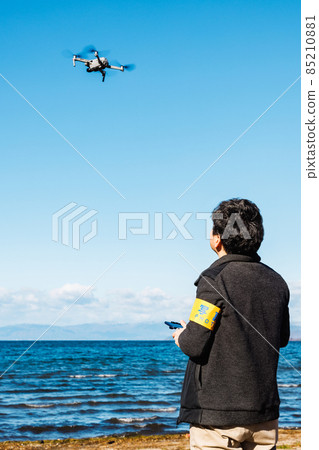 A man steering drone A man steering drone 85210881