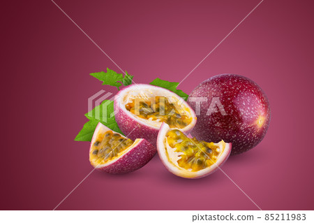 Whole passionfruit and a half of maracuya isolated on red background. 85211983