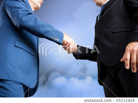 Mid section of two businessmen shaking hands against clouds in the sky Mid section of two businessmen shaking hands against clouds in the sky 85212828