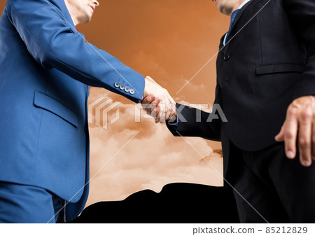Mid section of two businessmen shaking hands against clouds in the sky Mid section of two businessmen shaking hands against clouds in the sky 85212829