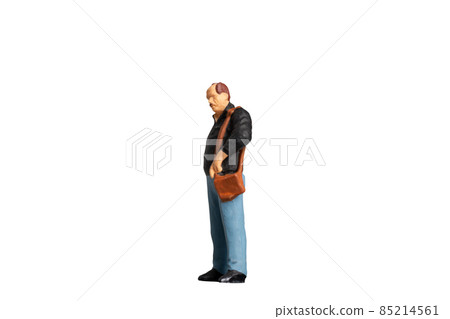 Miniature people Old man holding a shoulder bag standing on white background with clipping path Miniature people Old man holding a shoulder bag standing on white background with clipping path 85214561