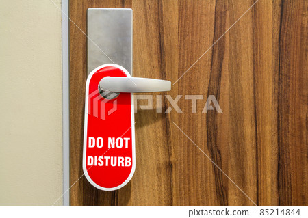 Door of hotel room with sign please do not disturb. Door of hotel room with sign please do not disturb. 85214844
