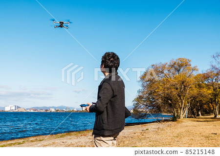 A man steering drone 85215148