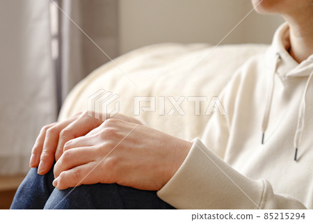 Female sitting on the floor in the room Female sitting on the floor in the room 85215294
