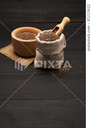 pouch full of Organic natural chia seeds on dark wooden background or table pouch full of Organic natural chia seeds on dark wooden background or table 85215622