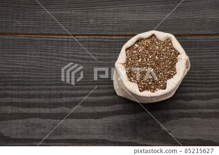 pouch full of Organic natural chia seeds on dark wooden background or table pouch full of Organic natural chia seeds on dark wooden background or table 85215627