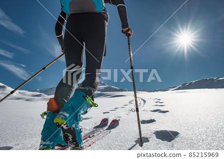 Ski mountaineer climbs on tracks with sealskin Ski mountaineer climbs on tracks with sealskin 85215969