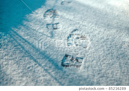 Footprint in the fresh winter snow. Abstract empty blank winter weather background 85216289
