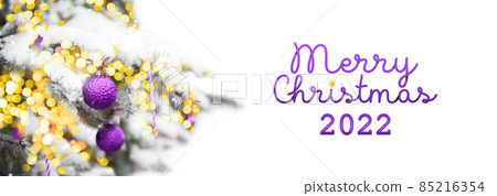 2022 Merry Christmas and New years Holiday web banner background. Template with Christmas lilac balls, snow on fir tree and lights. 2022 Merry Christmas and New years Holiday web banner background. Template with Christmas lilac balls, snow on fir tree and lights. 85216354