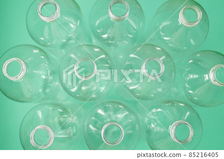 Empty plastic bottles on green background for recycling. Top view. Copy space. Plastic waste background. 85216405