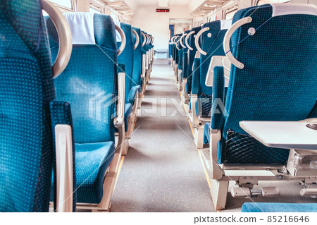 A modern train with blue empty comfortable and colorful chairs. A modern train with blue empty comfortable and colorful chairs. 85216646