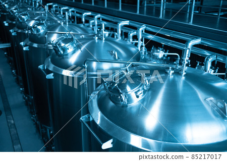 Private microbrewery. Modern beer plant with brewering kettles, tubes and tanks made of stainless steel Private microbrewery. Modern beer plant with brewering kettles, tubes and tanks made of stainless steel 85217017