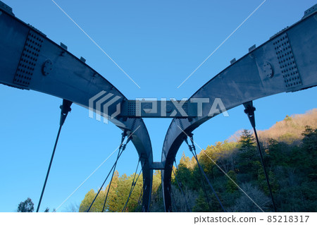 Arch bridge on a forest road Arch bridge on a forest road 85218317