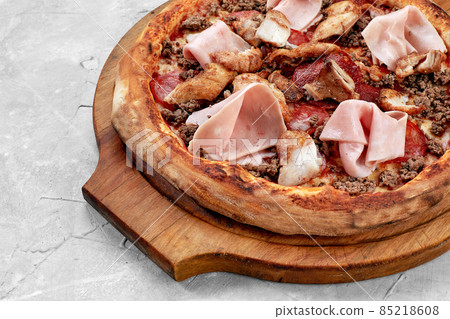 Meat Italian pizza with roast beef, steak slices, melted cheese, with olive slices and cheddar cheese. Close up, macro. Pizza time concept. Meat Italian pizza with roast beef, steak slices, melted cheese, with olive slices and cheddar cheese. Close up, macro. Pizza time concept. 85218608