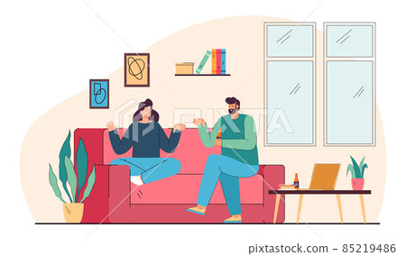 Couple people eating junk food, sitting on home couch 85219486