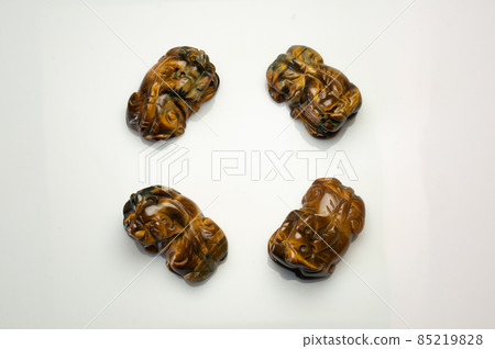 Natural tiger eye pet carving on the white background Natural tiger eye pet carving on the white background 85219828