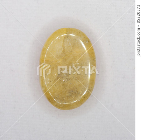 Natural yellow beryll oval cabochon on the white background Natural yellow beryll oval cabochon on the white background 85220573