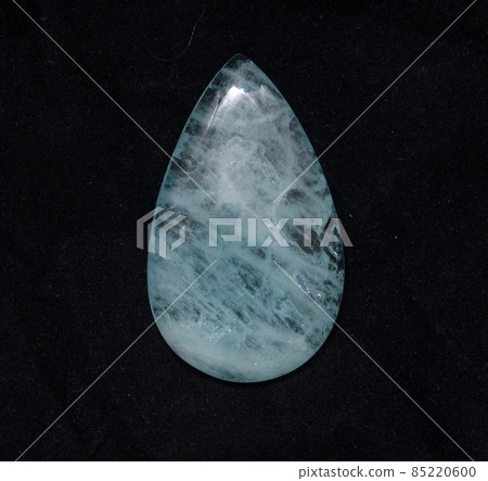 Natural blue aquamarine pear cabochon on the black background Natural blue aquamarine pear cabochon on the black background 85220600