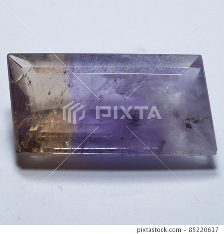 Natural yellow and purple ametrine on the white background 85220617