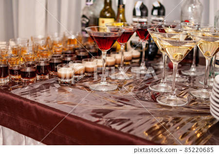 Desserts in the glasses lying on the brown table Desserts in the glasses lying on the brown table 85220685