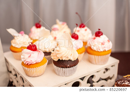 White sweet cupcakes on the white stand White sweet cupcakes on the white stand 85220697