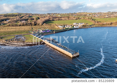 Coastal road and pier next to the Atlantic in Mountcharles in County Donegal - Ireland. Coastal road and pier next to the Atlantic in Mountcharles in County Donegal - Ireland. 85220809