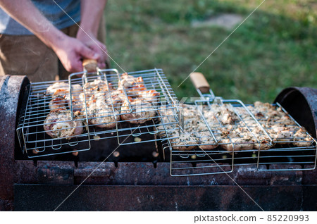 cooking raw meat in a grid on the barbeque grill cooking raw meat in a grid on the barbeque grill 85220993