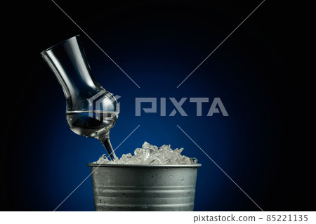 Vodka in a metal bucket with ice. Vodka in a metal bucket with ice. 85221135