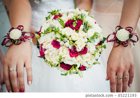 Bouquet of flowers in the hands of the girls 85221193