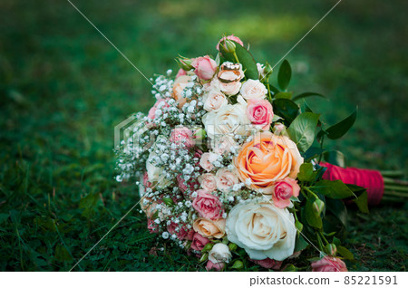 Gold wedding rings on the bouquet of flowers Gold wedding rings on the bouquet of flowers 85221591