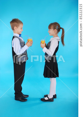 Girl and boy drink juice Girl and boy drink juice 85222315