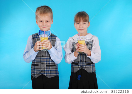 Girl and boy drink juice Girl and boy drink juice 85222316