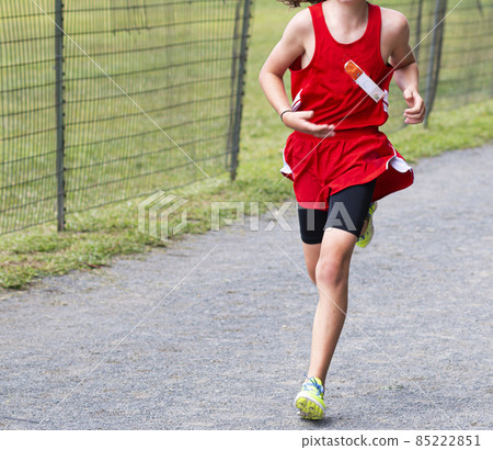 One cross country runner racing a 5K on a gravel path in the Bronx One cross country runner racing a 5K on a gravel path in the Bronx 85222851