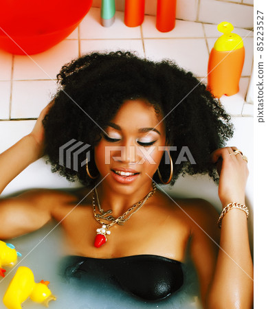 young african american teen girl laying in bath with foam, wearing swag jewelry flawless, making selfie young african american teen girl laying in bath with foam, wearing swag jewelry flawless, making selfie 85223527
