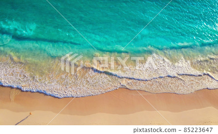 Aerial drone shot of turquoise sea water at beach 85223647
