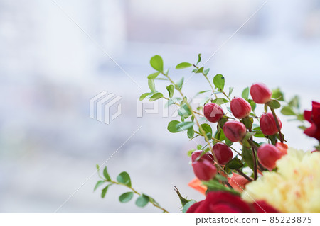 Part of the bouquet with the edge of barberry berries, green leaves, red rose. The concept of the holiday. Copy space. High quality photo Part of the bouquet with the edge of barberry berries, green leaves, red rose. The concept of the holiday. Copy space. High quality photo 85223875