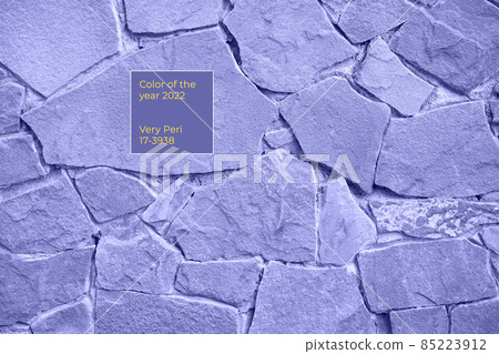 The texture of the stone wall, painted in the color of the year is very peri. High quality photo The texture of the stone wall, painted in the color of the year is very peri. High quality photo 85223912