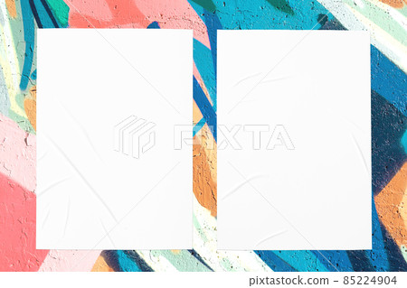 colorful urban wall with two wrinkled glued poster templates 85224904