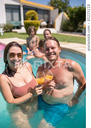 Relaxed family in swimming pool 85225218