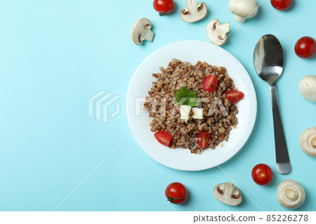 Concept of tasty eating with buckwheat on blue background 85226278