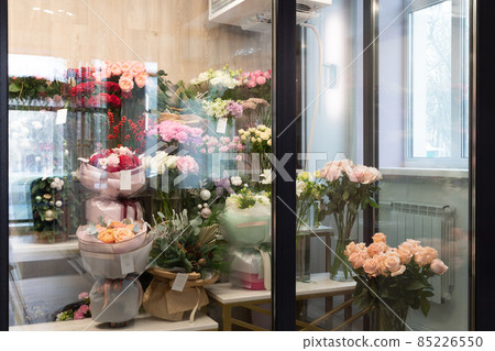 refrigerator in a flower shop with bouquets on the shelves refrigerator in a flower shop with bouquets on the shelves 85226550