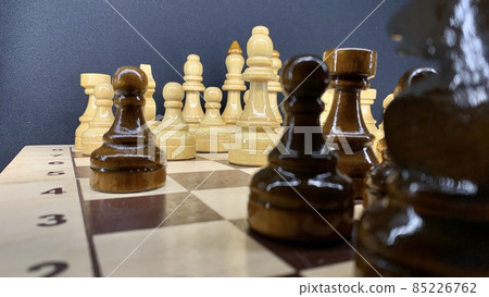 Handmade wooden chess set varnished on a wooden board for playing 85226762