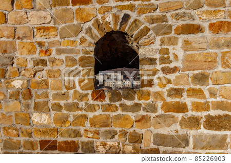 Background of the old stone wall with a loophole 85226903