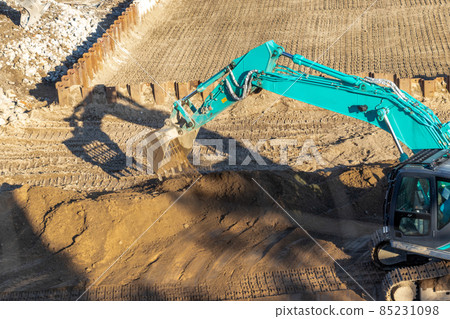 Hydraulic excavator working at a construction site 85231098