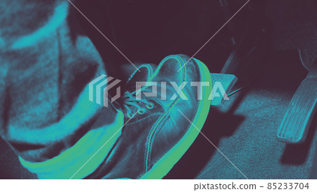 Accelerator and breaking pedal in a car. Close up the foot pressing foot pedal of a car to drive ahead. Driver driving the car by pushing accelerator pedals of the car. Foot pedals inside vehicle. 85233704
