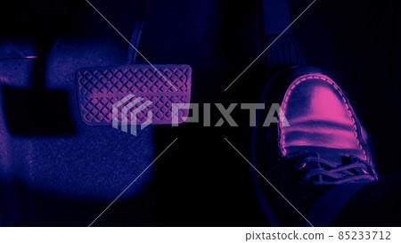 Accelerator and breaking pedal in a car. Close up the foot pressing foot pedal of a car to drive ahead. Driver driving the car by pushing accelerator pedals of the car. Foot pedals inside vehicle. 85233712