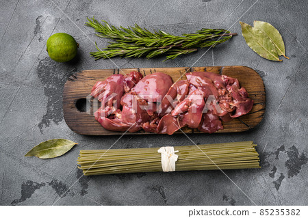 Fresh chicken liver, raw offal, ingredients, on gray stone table background, top view flat lay Fresh chicken liver, raw offal, ingredients, on gray stone table background, top view flat lay 85235382