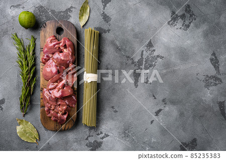 Fresh chicken liver and ingredients, on gray stone table background, top view flat lay, with copy space for text 85235383