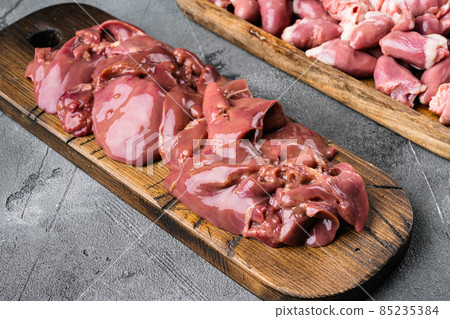 Raw chicken liver meat with thyme, on gray stone table background, with copy space for text Raw chicken liver meat with thyme, on gray stone table background, with copy space for text 85235384